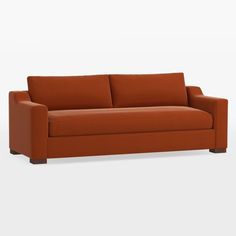 an orange couch sitting on top of a white floor