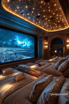 a large room with many couches and a projection screen in the middle of it