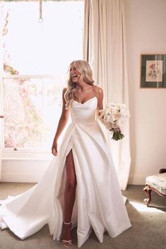 a woman in a white wedding dress is posing for the camera with her legs high