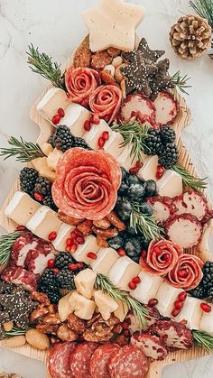 a platter filled with meats, cheeses and fruit