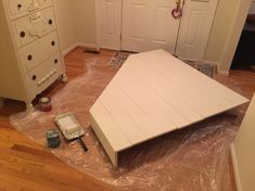 the room is being prepared for painting and remodeling with plastic covering the floor