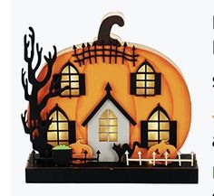 a halloween scene with pumpkins, bats and other decorations in front of a house