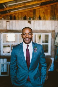 a man in a blue suit and red tie