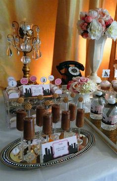 a table topped with lots of cupcakes and cakes