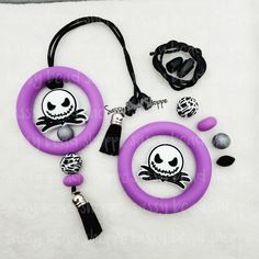 two purple rings with jack skellingy faces on them, one is black and the other is white