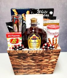 a wooden basket filled with liquor and snacks