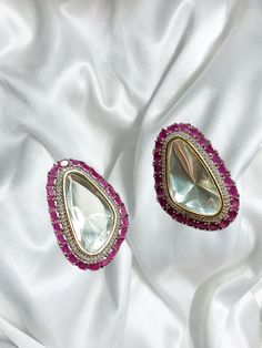 Beautiful vintage uncut polki stud earrings with silver diamond work and a modern luxurious look for any jewelry lover! The Pink stones are a beautiful pop of color with the bold diamond in the middle and these are the perfect statement earrings beautifully handmade for all occasions! These lightweight and elegant stud earrings is perfect for any bridesmaid, bride, sangeet or any occasion or event as a gift for any occasion as any one who loves jewelry will love this statement piece. It has beau Fusion Stone Work Earrings For Party, Diamond White Gemstone Earrings For Parties, American Diamond Fusion Earrings For Party, Rose Cut Diamond Earrings For Party, Fusion Style American Diamond Earrings, Fusion Style American Diamond Party Earrings, Traditional Party Earrings With Gemstones, Traditional Gemstone Earrings For Party, Dazzling Gemstone Earrings For Party