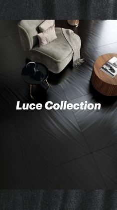 a living room with black tile flooring and a white chair next to a coffee table