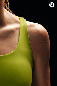 a close up of a woman wearing a green sports bra