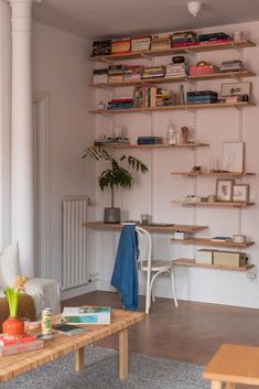 a living room filled with furniture and bookshelves on top of it's shelves