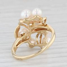 Gemstone Information:  - Cultured Saltwater Pearls -  Size - 4.6 - 5.1 mm  Cut - Round Bead Shape  Color - White    Metal: 18k Yellow Gold  Weight: 5.1 Grams  Stamps: 750  Face Height: 18.8 mm  Rise Above Finger: 9.6 mm  Band / Shank Width: 1.5 mm    This ring is a size 6 1/4, but it can be resized down 2 sizes for a $20 fee or up 3 sizes for a $40 fee.        Each piece is thoroughly examined and refinished as needed by our professional jewelers, graded by our in-house GIA (Gemological Institute of America) Graduate Gemologist, and inspected for quality before being carefully packaged and promptly shipped. Formal 14k Gold Pearl Ring With 17 Jewels, Formal Yellow Gold Pearl Ring With 17 Jewels, High Luster Yellow Gold 14k Ring, Yellow Gold Multi-stone Jewelry For Anniversary, Anniversary Multi-stone Yellow Gold Jewelry, Heirloom High Luster Ring, Timeless Gold Cluster Jewelry, Yellow Gold Multi-stone Jewelry, Heirloom High Luster Ring Jewelry