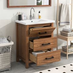 a bathroom vanity with drawers and a mirror