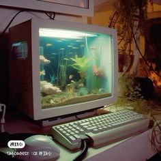 an old computer monitor sitting on top of a desk next to a keyboard and mouse