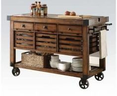 a kitchen island with drawers and baskets on it's wheels, is shown in this image