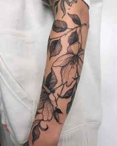 a woman's arm with flowers on it