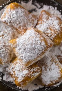 powdered sugar covered pastries in a bowl