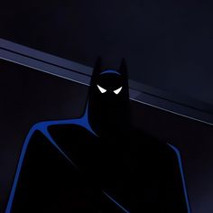 the batman animated character with glowing eyes and caped head, standing in front of a dark background