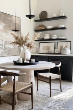 a dining room table with chairs and plates on it