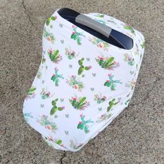 an oven mitt sitting on the ground with cactus print covering it's back