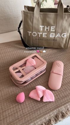 the tote bag is sitting on top of a table next to some pink objects