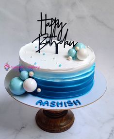 a blue and white birthday cake with happy birthday written on it