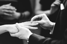 the bride and groom are exchanging their wedding rings