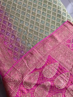 A Handmade Mehndi Green & Fuchsia Pink shaded Pure Khaddi Georgette Bandhani/ Bandhej Saree woven in pure Meenakari Zari- an invitation for a true self-indulgence. The fall and pico are done for this saree. It comes along with a Fuchsia Pink Bandhani Blouse piece that also has a zari border.   Our Policy on Returns, refunds and exchanges: We don't accept requests for returns and exchanges on the below observations: Non-defects: *Small knots or bumps in the silk threads.  *Uneven threads because Pink Self-design Unstitched Dupatta, Pink Self-design Dupatta, Pink Anarkali Salwar Kameez With Zari Weaving, Pink Chanderi Anarkali Set With Motifs, Festive Pink Anarkali Set With Motifs, Pink Dola Silk Dupatta For Transitional Season, Pink Anarkali Set With Motifs For Diwali, Pink Banarasi Silk Sharara For Transitional Season, Transitional Pink Banarasi Silk Sharara