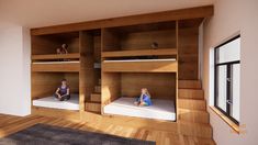 two children are sitting on bunk beds in a room with wood flooring and white walls