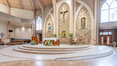 the inside of a church with pews and flowers