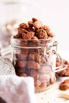 a glass jar filled with nuts on top of a table