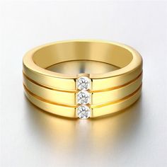 three gold wedding bands with diamonds on them, against a white background and the words agenwed written below