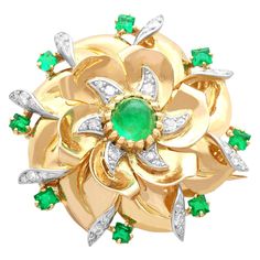 A stunning, fine and impressive French 1.70 carat emerald and 0.39 carat diamond, 18 karat yellow gold and platinum set brooch; part of our diverse gemstone jewelry and estate jewelry collections. This stunning, fine and impressive vintage brooch has been crafted in 18k yellow gold with platinum settings. The brooch has a curvilinear, swirling floral design, with two rows of petals. This vintage brooch is embellished with a central stunning cabochon cut emerald encompassed with six-pointed stellate style platinum settings, ornamented with twelve pavé set diamonds. The shaped outer circumference of the brooch is encompassed with eight individually claw set emeralds, in a combination of square and rectangular cuts. The outer swirl design is further embellished with eight platinum settings, e Unique Brooch, Gold Brooch, Heart Brooch, Gold Brooches, Gemstone Jewellery, Swirl Design, Antique Diamond, Emerald Jewelry, Vintage Brooch