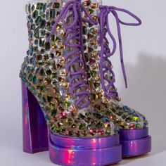 When You’re Ready! Na, Na, Na, Na All You Want With The Azalea Wang Came In The Party Lit Chunky Bootie In Purple Multi. This Pvc Bootie Features A Square Toe Silhouette, Lace Up Vamp, Ankle Height Shaft, And A Holographic Block Heel And Coordinating Platform Base. Complete With Glass-Like Rhinestone Gemstone Embellishments. -All Man-Made Materials -Square Toe -Chunky Heel -Inside Zipper Closure -6” Heel Height, 2.25” Platform, 5.5” Shaft Height -Square Toe -Chunky Heel Purple Platform Heels For Party, Glamorous Purple Party Heels, Purple High Heel Party Heels, Purple Boots For Night Out, Glamorous High Heel Purple Boots, Glamorous Fitted Purple Heels, Multicolor High Heel Party Boots, Purple Pointed Toe Boots For Night Out, Party Boots With Rhinestones And Lace-up