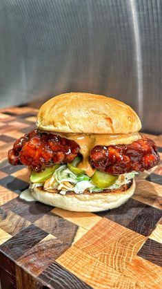 a chicken sandwich sitting on top of a wooden table