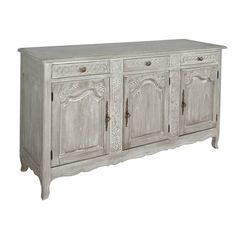 an old white wooden sideboard with ornate carvings on the doors and drawers, isolated against a white background