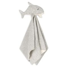 a white towel hanging on the wall with a fish shaped object attached to it's side