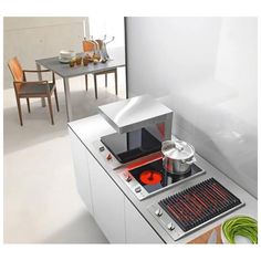 a stove top oven sitting on top of a white counter