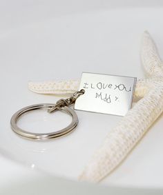 a keychain that says i love you and has a starfish on it