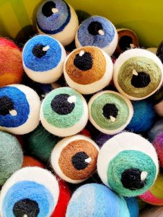 there are many different colored balls with eyes on them