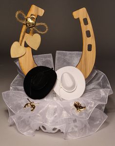 a hat and other items are placed on a table top with tulle under it