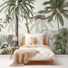 an animal themed bedroom with palm trees and giraffes on the wallpaper