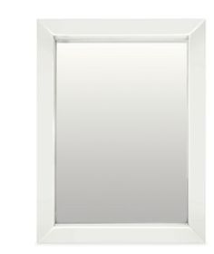 a white framed mirror on a white wall with clippings to the bottom and bottom