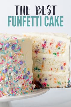 a cake with white frosting and sprinkles on the top is cut into pieces