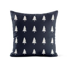 a black pillow with white trees on it