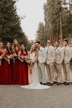 a group of people standing next to each other in front of some tall pine trees