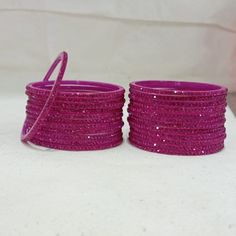 Bangles Name - Penali Burj Khalifa   Color - Rani   Size - 2.2/2.4/2.6/2.8   Weight - 60 grams   Piece - 12   Stone Color- Rani  100% Glass Bangles & Handmade Product. You can wear it while going to a wedding by matching it with your clothes. You can also gift it to someone. You can also wear it in an engagement. It looks very beautiful in your hands. about shipping  Ships within 1 to 3 business days after payment is received  We ship orders every day except Sundays and holidays  When your order Plastic Bangle Jewelry For Party, Plastic Round Jewelry For Parties, Round Plastic Party Jewelry, Pink Plastic Bangle Jewelry, Color Bracelets, 12 Stones, Glass Bangles, Fancy Jewellery Designs, Bangles For Women