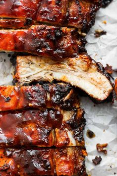 ribs covered in bbq sauce on top of paper