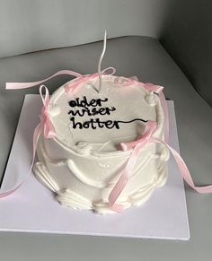 a white cake with pink ribbon and an inscription on it that reads, older mister potter