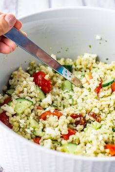 someone is cutting up some food in a bowl