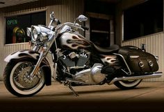 a black and silver motorcycle parked in front of a building